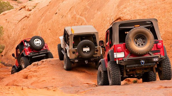 Jeep - Trucks climbing rocky terrain in Moab, Utah