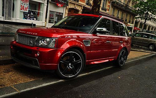 gotta love the candy apple red Range Rover Sport with black tint on those black rims