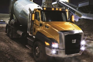 The #Cat vocational truck equipped with a concrete mixer.
